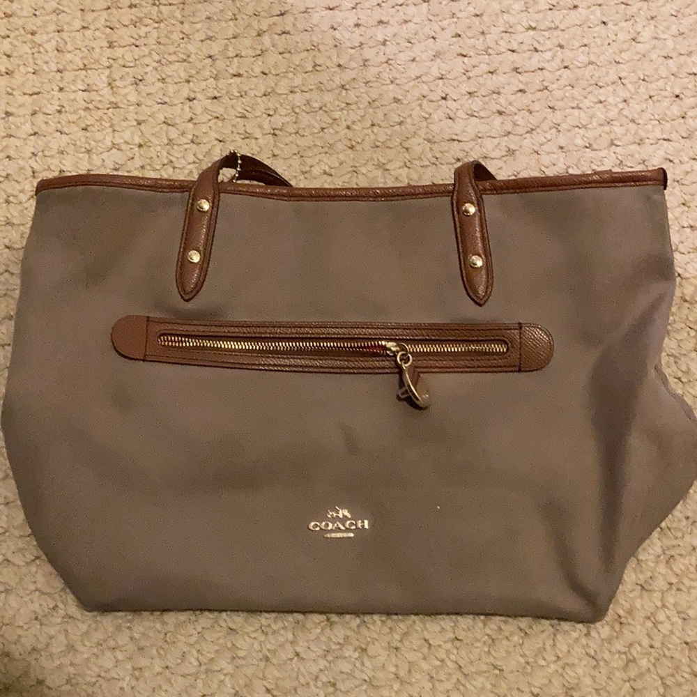 Coach tan bag with brown leather straps, gold fixtures and orange interior